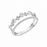 white gold double-band ring with a beaded strand, bezel-set stones, and polished gold spheres on white background