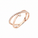 rose gold crossover ring with a paved band and a single suspended clear stone on white background
