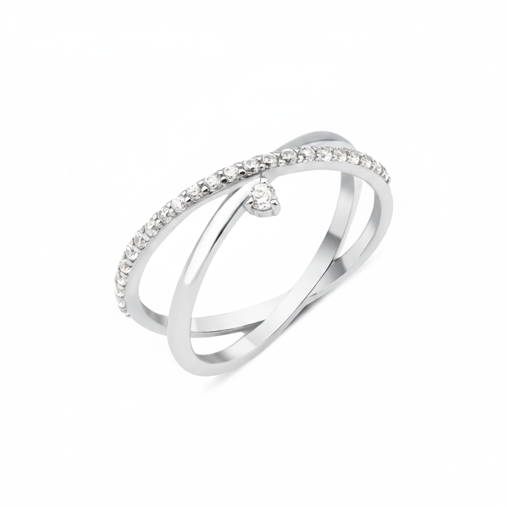 white gold crossover ring with a paved band and a single suspended clear stone on white background
