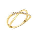 yellow gold open crossover ring with a paved arch and a single solitaire stone on white background