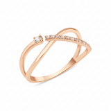 rose gold open crossover ring with a paved arch and a single solitaire stone on white background