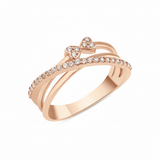 rose gold crossover ring with a pave strand and twin heart motifs set with clear stones on white background
