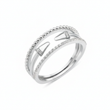 white gold multi-strand ring with beaded, pave, and cone-tipped bands on white background