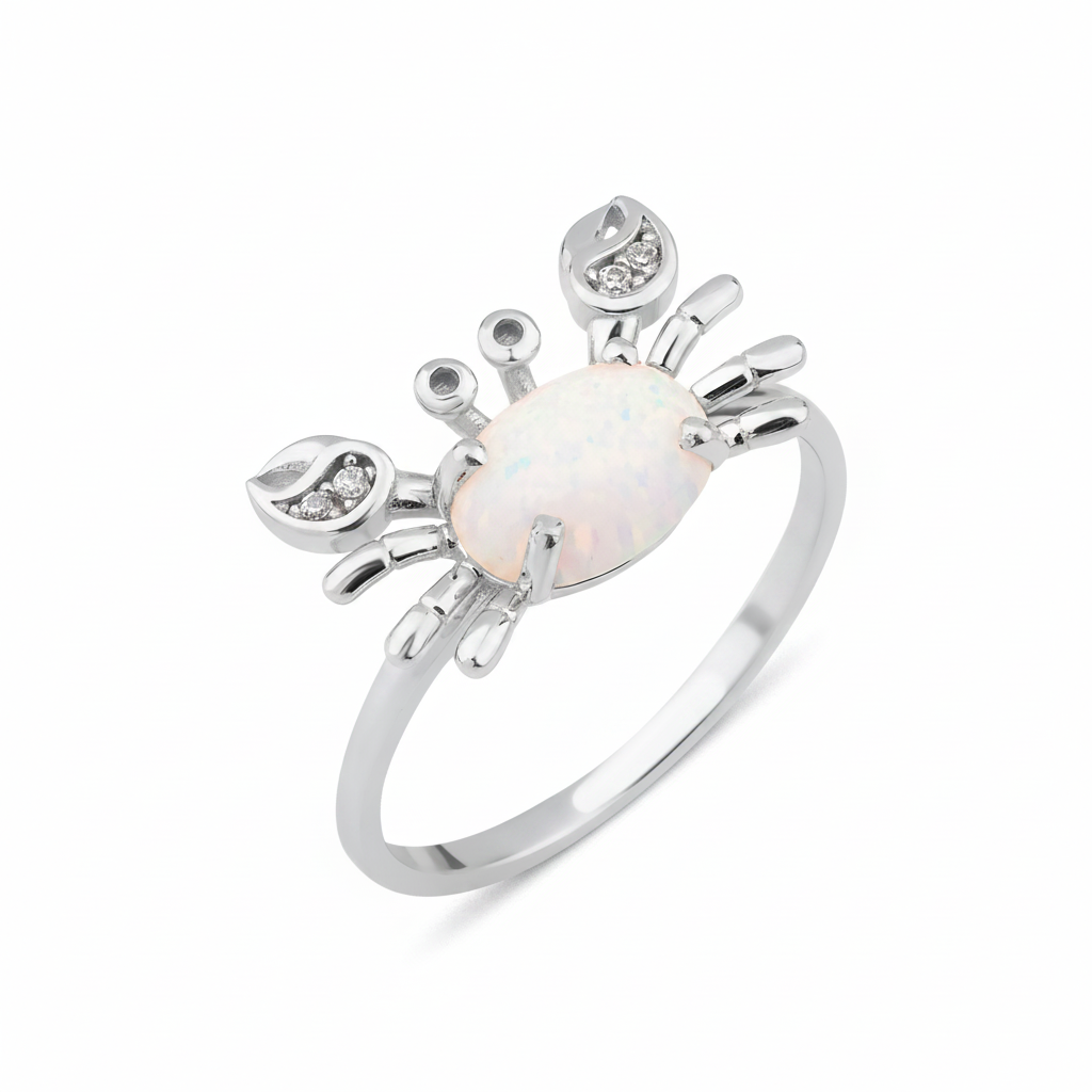 white gold crab ring with an iridescent white stone and clear accents on white background