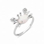 white gold crab ring with an iridescent white stone and clear accents on white background