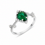 white gold ring with an oval green stone and White CZ accents on a beaded band on white background