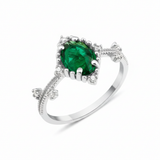 white gold ring with an oval green stone and White CZ accents on a beaded band on white background