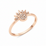 rose gold sunburst ring with a pave stone cluster and radiant rays on white background
