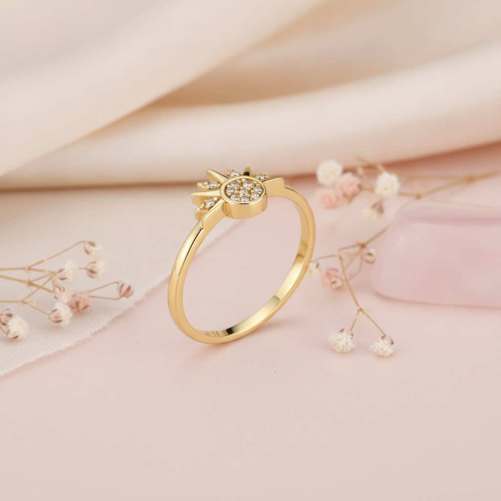 gold sunburst ring with a pave stone cluster and radiant rays, styled with dried flowers on a blush background