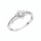 white gold ring with a sunburst motif, central clear stone, and beaded band on white background