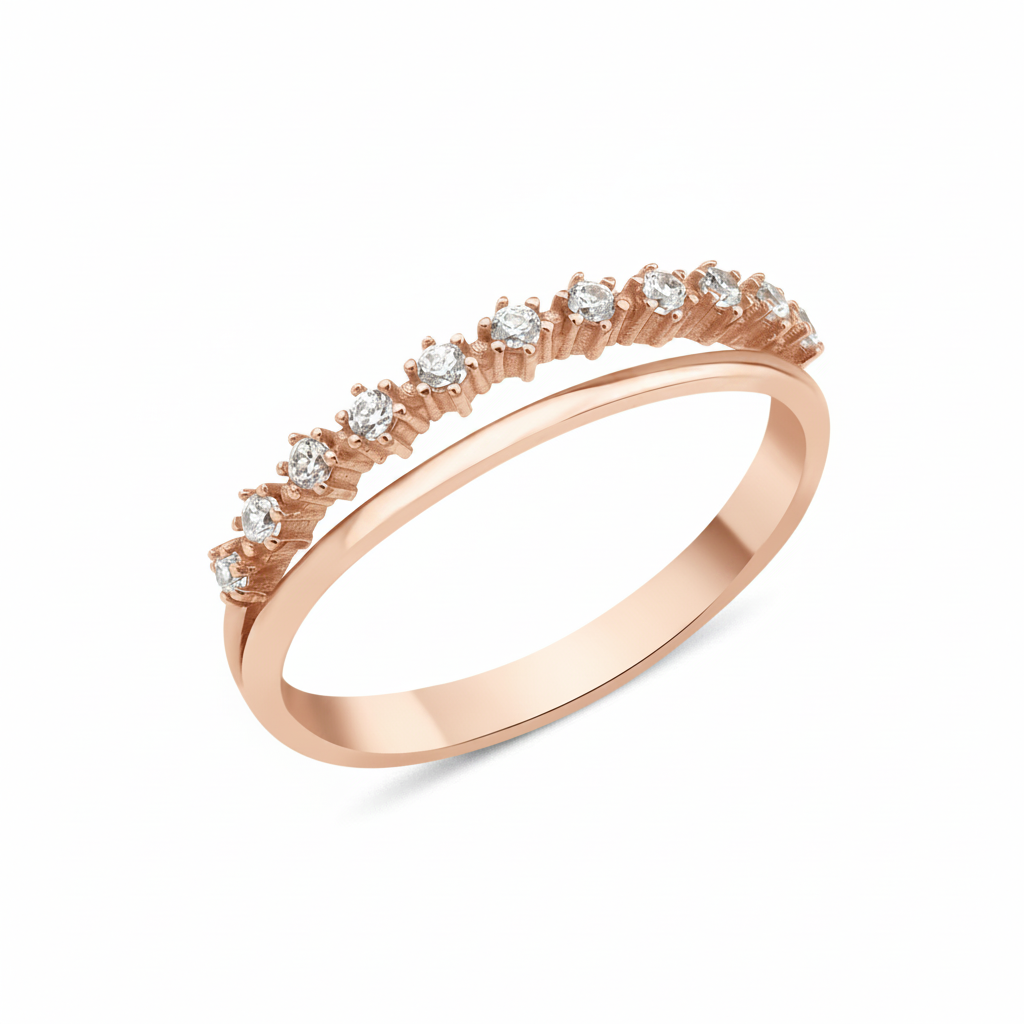 rose gold ring with a smooth band and a parallel arc of prong-set clear stones on white background