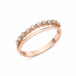 rose gold ring with a smooth band and a parallel arc of prong-set clear stones on white background
