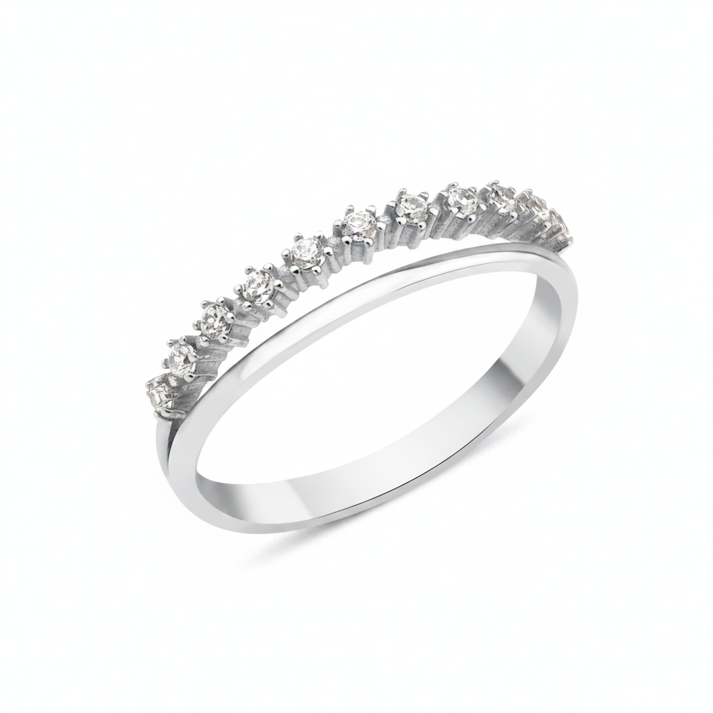 white gold ring with a smooth band and a parallel arc of prong-set clear stones on white background