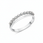 white gold ring with a smooth band and a parallel arc of prong-set clear stones on white background