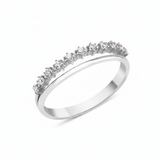 white gold ring with a smooth band and a parallel arc of prong-set clear stones on white background