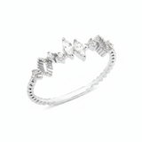 white gold ring with marquise-cut and round stones on a textured geometric band on white background