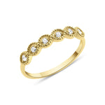 yellow gold ring with six round stones in milgrain bezels on white background