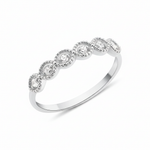 white gold ring with six round stones in milgrain bezels on white background