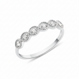 white gold ring with six round stones in milgrain bezels on white background