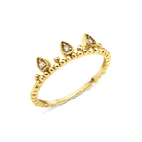 yellow gold ring with three teardrop crown crests set with clear stones on white background