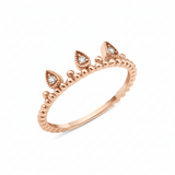 rose gold ring with three teardrop crown crests set with clear stones on white background
