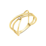 yellow gold crossing paths ring on white background
