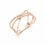 rose gold crossing paths ring on white background