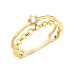 yellow gold smooth beaded ring on white background
