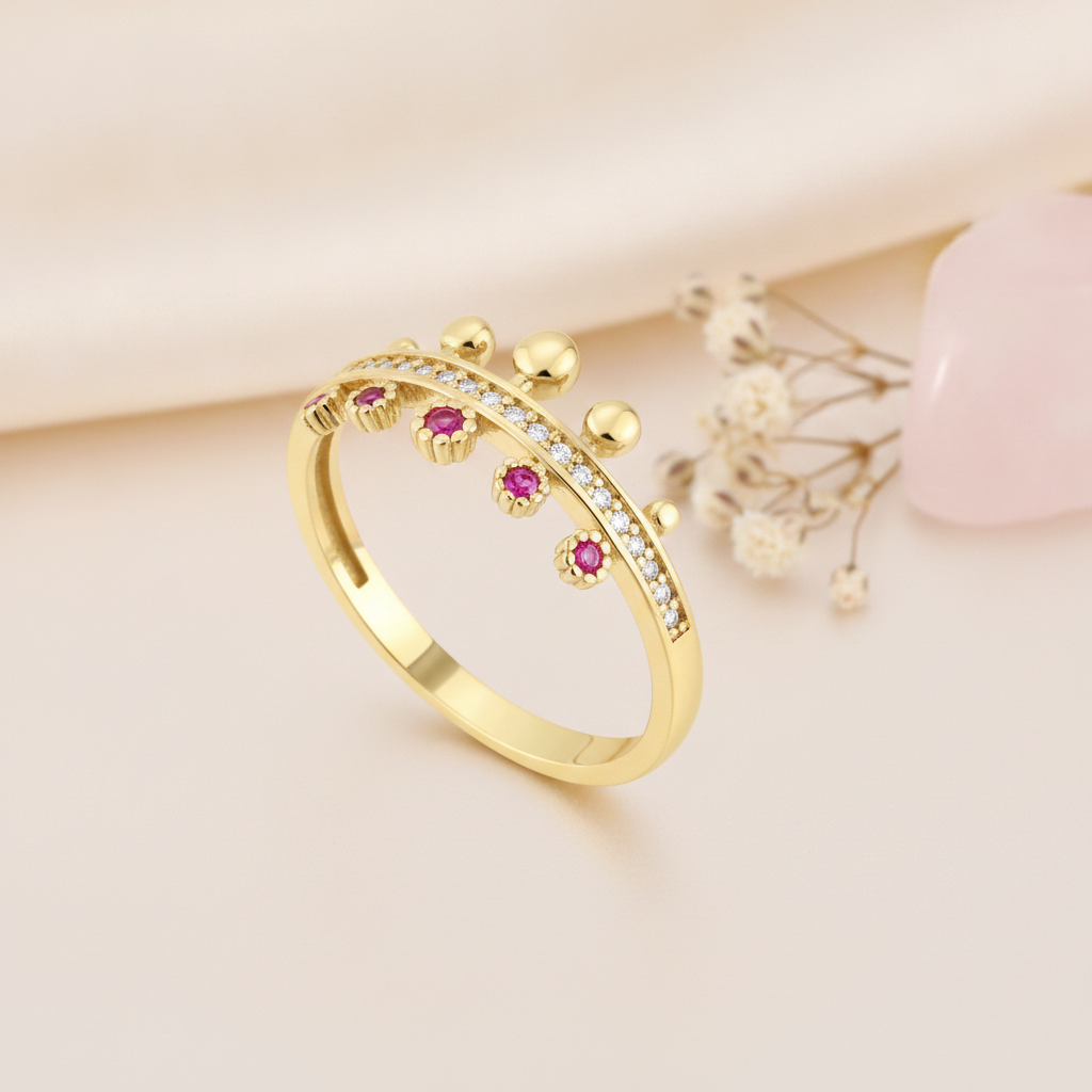 crown-shaped gold ring with pink gems, clear pave stones, and gold beads on pink silk with a rose quartz stone and dried flowers