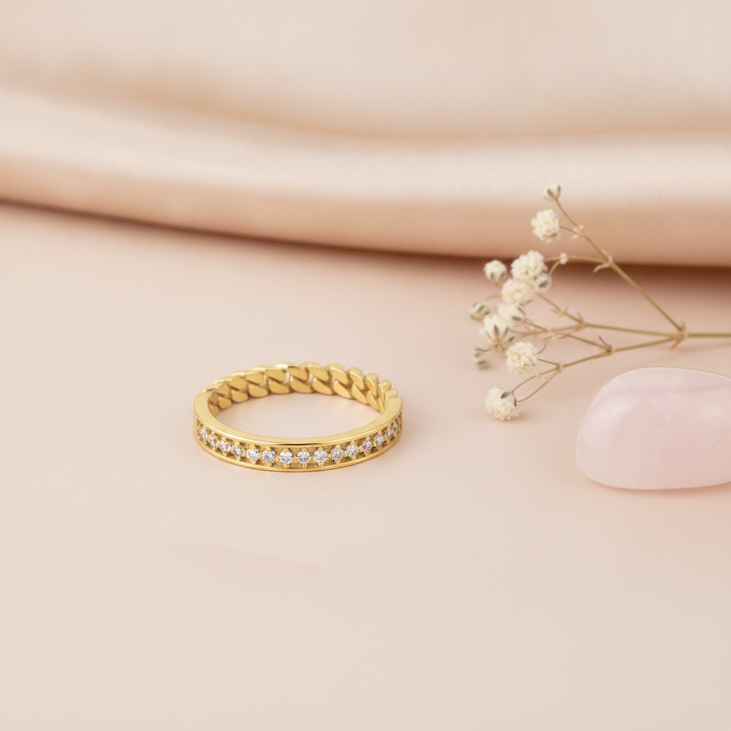 two-texture gold ring with a pave row transitioning into a curb-link chain on pink silk with dried flowers