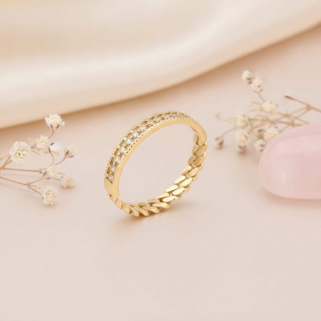 gold ring transitioning from a curb-chain texture into a pave row with beaded borders on blush pink silk with dried flowers