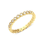 yellow gold bezel eternity ring on white background