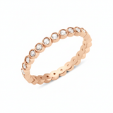 rose gold bezel eternity ring on white background