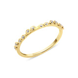 yellow gold dotted bezel ring on white background