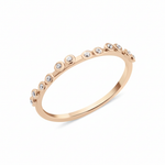 rose gold dotted bezel ring on white background