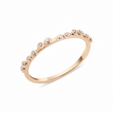 rose gold dotted bezel ring on white background