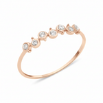 rose gold arc bezel ring on white background
