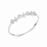 white gold arc bezel ring on white background