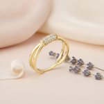 gold ring with a pave bar set across a split-shank band on blush silk with a lavender sprig and ribbon