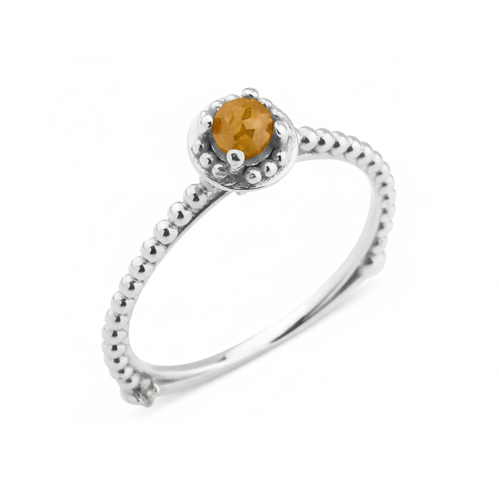 white gold beaded ring with a golden-yellow stone on white background