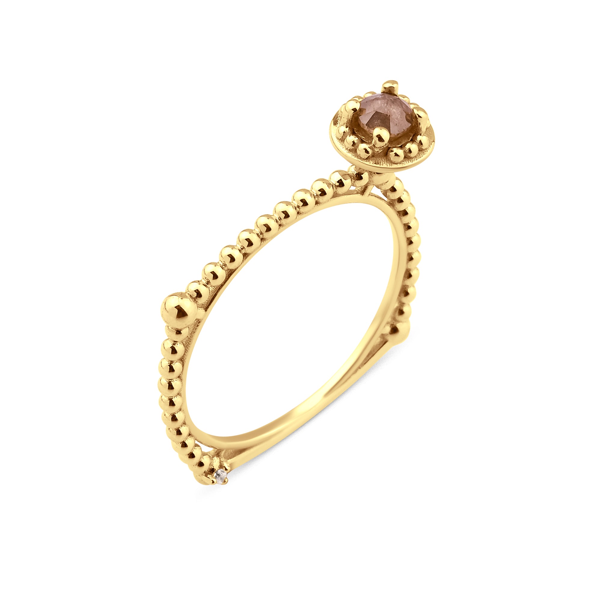 yellow gold beaded ring with a crowned center stone on white background
