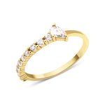yellow gold ring lined with pave stones and a pear-cut stone on white background