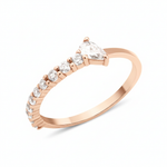 rose gold ring lined with pave stones and a pear-cut stone on white background