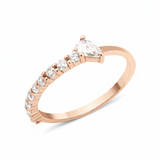 rose gold ring lined with pave stones and a pear-cut stone on white background