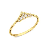 yellow gold beaded ring with a chevron of pave stones on white background