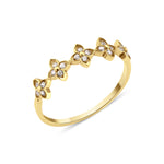 yellow gold ring with four-petal flower motifs on white background