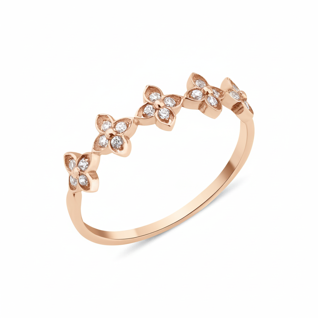 rose gold ring with four-petal flower motifs on white background