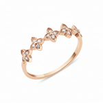 rose gold ring with four-petal flower motifs on white background