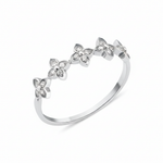 white gold ring with four-petal flower motifs on white background