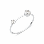 white gold open ring with two bezel-set stones on white background